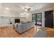 Cozy living room features a decorative brick fireplace, ceiling fan, and French doors at 11035 W 26Th Pl, Lakewood, CO 80215