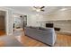 Open concept living room with fireplace and hardwood flooring, flowing into an adjacent office space at 11035 W 26Th Pl, Lakewood, CO 80215