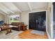 Bright living room features a beamed ceiling, hardwood floors and comfortable furniture at 11035 W 26Th Pl, Lakewood, CO 80215