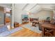 Cozy living room featuring hardwood floors, beamed ceiling, and seamless flow into the adjacent kitchen at 11035 W 26Th Pl, Lakewood, CO 80215