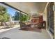 Covered patio with outdoor furniture and view of the wooden deck above at 11035 W 26Th Pl, Lakewood, CO 80215