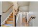 Stairway with wood steps and wrought iron detailing, leading to an upstairs living area at 11035 W 26Th Pl, Lakewood, CO 80215