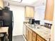 Kitchen featuring wooden cabinets, black appliances, and neutral countertops, perfect for any home chef at 4281 S Salida Way # 5, Aurora, CO 80013