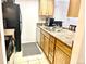 Kitchen featuring wooden cabinets, black appliances, and neutral countertops, perfect for any home chef at 4281 S Salida Way # 5, Aurora, CO 80013