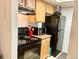 Kitchen featuring wooden cabinets, black appliances, and neutral countertops, perfect for any home chef at 4281 S Salida Way # 5, Aurora, CO 80013