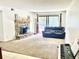 Spacious living room featuring a stone fireplace, plush carpeting, and sliding glass doors to a patio at 4281 S Salida Way # 5, Aurora, CO 80013