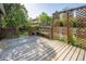 Wooden back deck featuring a bench and trellis, surrounded by trees and greenery at 2935 Bow Line Pl, Longmont, CO 80503