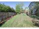 Well-maintained backyard with lush green grass, flowerbeds, and a wooden fence at 2935 Bow Line Pl, Longmont, CO 80503