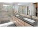 Contemporary bathroom featuring a double vanity, glass shower, and large mirror at 2935 Bow Line Pl, Longmont, CO 80503