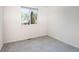 Bright and airy bedroom with carpet flooring and a large window overlooking the neighborhood at 2935 Bow Line Pl, Longmont, CO 80503