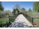 A concrete bridge with black metal railings surrounded by greenery under a clear sky at 2935 Bow Line Pl, Longmont, CO 80503