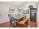 Comfortable dining room featuring a farmhouse table, rustic light fixture, and hardwood floors at 2935 Bow Line Pl, Longmont, CO 80503
