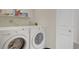 Functional laundry room with a washer, dryer, and shelving for storage at 2935 Bow Line Pl, Longmont, CO 80503