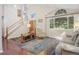 Bright living room with vaulted ceilings, hardwood floors, large windows and elegant staircase at 2935 Bow Line Pl, Longmont, CO 80503