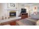 Cozy living room with a fireplace, hardwood floors, and comfortable seating at 2935 Bow Line Pl, Longmont, CO 80503