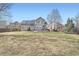 Large backyard with grass and patio, and solar panels on the home's roof at 9306 W 13Th Pl, Lakewood, CO 80215