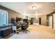 Spacious carpeted basement with computer desks and windows providing natural light at 9306 W 13Th Pl, Lakewood, CO 80215