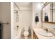 Clean, well-lit bathroom features a shower-tub combination and classic fixtures at 9306 W 13Th Pl, Lakewood, CO 80215