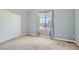 Neutral bedroom with a window and closet with carpet flooring at 9306 W 13Th Pl, Lakewood, CO 80215