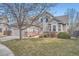 Charming two-story home with brick accents, mature tree, and well-maintained lawn at 9306 W 13Th Pl, Lakewood, CO 80215