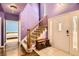 Bright entryway with staircase, tiled floor, and view into the bedroom at 9306 W 13Th Pl, Lakewood, CO 80215