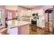 Modern kitchen features stainless steel appliances, white cabinetry, and hardwood flooring at 9306 W 13Th Pl, Lakewood, CO 80215