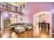 Bright living room with vaulted ceilings, staircase and view into the dining room at 9306 W 13Th Pl, Lakewood, CO 80215
