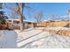 Large backyard with detached garage and deck. Snow covered in winter at 4070 W Dartmouth Ave, Denver, CO 80236