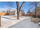 Spacious backyard with detached garage and snow covered ground at 4070 W Dartmouth Ave, Denver, CO 80236