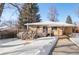 Backyard with detached garage, deck and covered patio. Snow covered in winter at 4070 W Dartmouth Ave, Denver, CO 80236