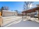 Large backyard with detached garage and covered patio. Snow covered in winter at 4070 W Dartmouth Ave, Denver, CO 80236