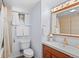 Clean basement bathroom with a tub, toilet, and updated vanity at 4070 W Dartmouth Ave, Denver, CO 80236