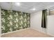 Finished basement bedroom with patterned wallpaper and carpeted floors at 4070 W Dartmouth Ave, Denver, CO 80236