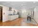 Finished basement with kitchenette, modern cabinets, and wood flooring at 4070 W Dartmouth Ave, Denver, CO 80236