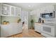 Bright eat-in kitchen with white cabinets, stainless steel appliances, and wood flooring at 4070 W Dartmouth Ave, Denver, CO 80236