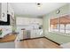 Modern kitchen featuring white cabinets, stainless steel appliances, and light wood floors at 4070 W Dartmouth Ave, Denver, CO 80236