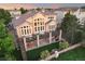 Aerial view of a backyard featuring a spacious deck, stairs, and lush landscaping around the property at 6047 Vacquero Cir, Castle Pines, CO 80108