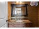 Powder room with a marble vanity, decorative mirror, updated faucet and lighting at 6047 Vacquero Cir, Castle Pines, CO 80108