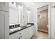 Modern bathroom featuring double vanity and glass-enclosed shower at 6047 Vacquero Cir, Castle Pines, CO 80108
