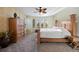 Spacious bedroom with a ceiling fan, carpet floors and large windows with backyard views at 6047 Vacquero Cir, Castle Pines, CO 80108