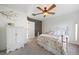 Bright bedroom with floral bedding, ceiling fan, and white armoire at 6047 Vacquero Cir, Castle Pines, CO 80108