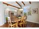 Dining room featuring hardwood floors, exposed beams, and a large wooden table at 6047 Vacquero Cir, Castle Pines, CO 80108