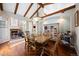 Dining room featuring a large wooden table, hardwood floors, and access to a cozy outdoor patio with a fireplace at 6047 Vacquero Cir, Castle Pines, CO 80108