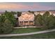 Aerial view of the exterior of a two story home with large windows and green grass at 6047 Vacquero Cir, Castle Pines, CO 80108