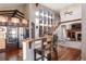 Gourmet kitchen featuring stainless steel appliances, breakfast bar with chairs, and hardwood floors at 6047 Vacquero Cir, Castle Pines, CO 80108