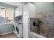Convenient laundry room with adjacent dog-wash area and modern washer and dryer at 6047 Vacquero Cir, Castle Pines, CO 80108