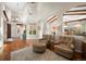 Open-concept living area featuring vaulted ceilings, hardwood floors and stylish furnishings at 6047 Vacquero Cir, Castle Pines, CO 80108