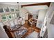 Open-concept living room with hardwood floors, large windows, a ceiling fan, and a view of the kitchen area at 6047 Vacquero Cir, Castle Pines, CO 80108