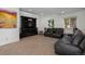 Media room with large television and black leather seating at 6047 Vacquero Cir, Castle Pines, CO 80108