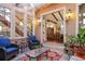 Charming outdoor patio featuring stone flooring, comfortable seating, and views of the interior living space at 6047 Vacquero Cir, Castle Pines, CO 80108